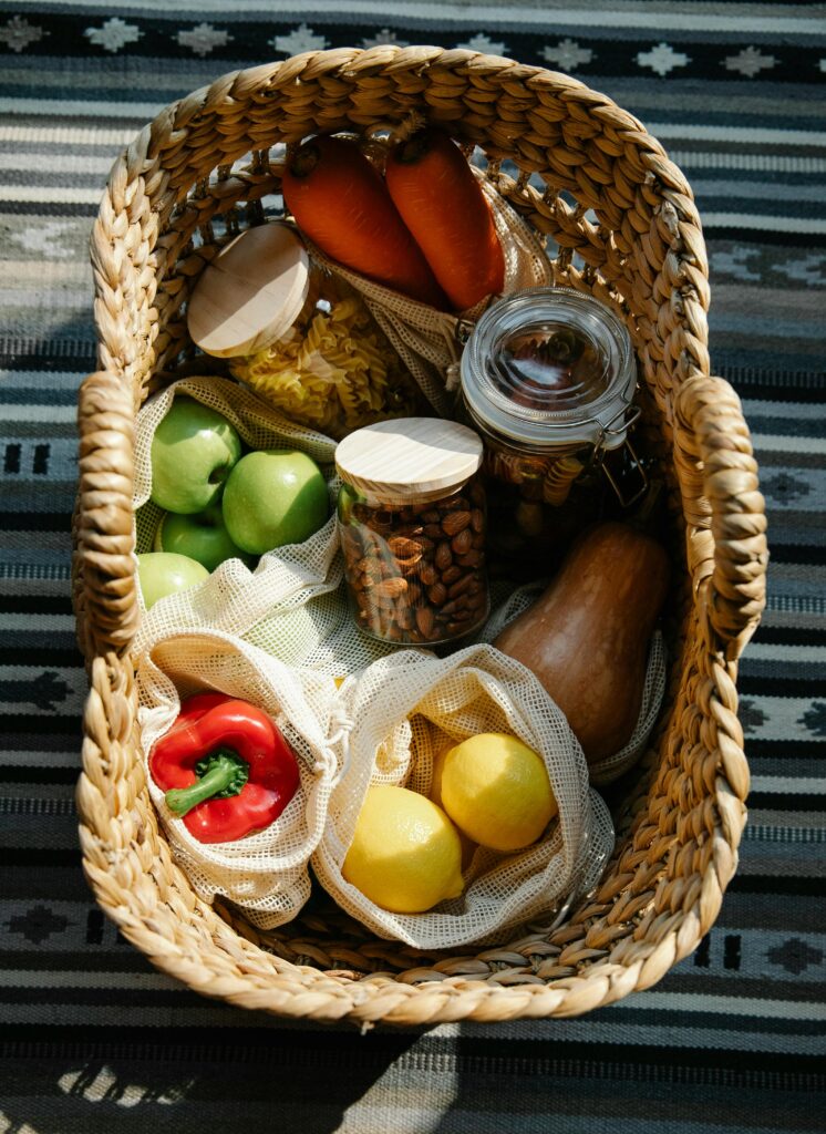 "Grocery bag with fresh produce and proper storage boxes."