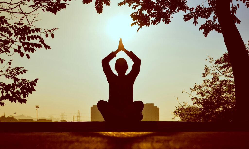 Person practicing yoga for self-care and motivation.