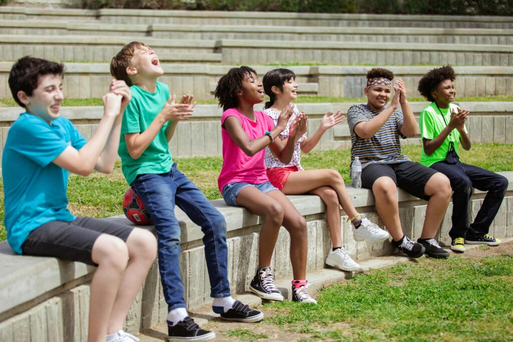Friends laughing together to boost positive mindset and motivation.