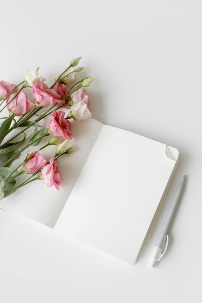 An open, blank journal on a wooden desk in soft light, representing a fresh start and new possibilities after letting go.