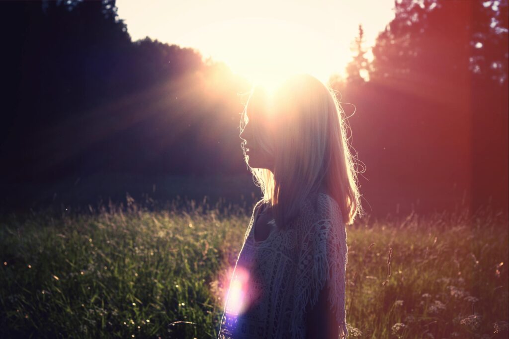 A vast meadow with a clear horizon at sunset, symbolizing freedom and new possibilities after letting go of burdens.
