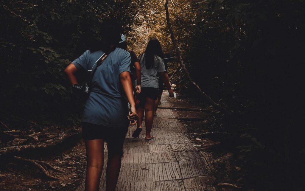 Persons taking a step forward on path, beginning to overcome fear.