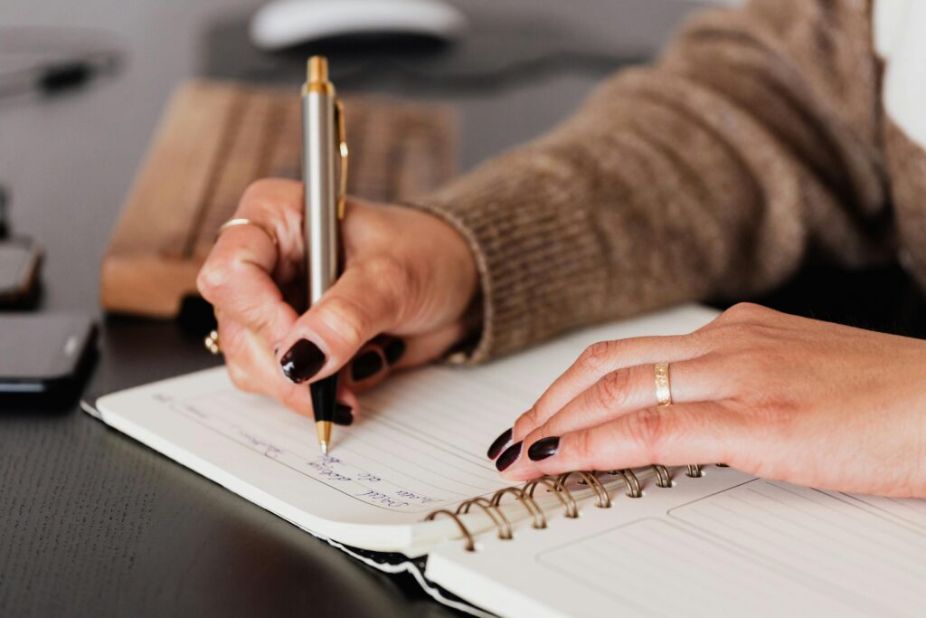 Person writing in journal, acknowledging fears.